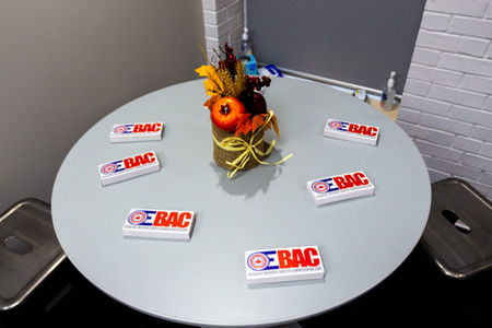 Table with small boxes with OEBAC logo